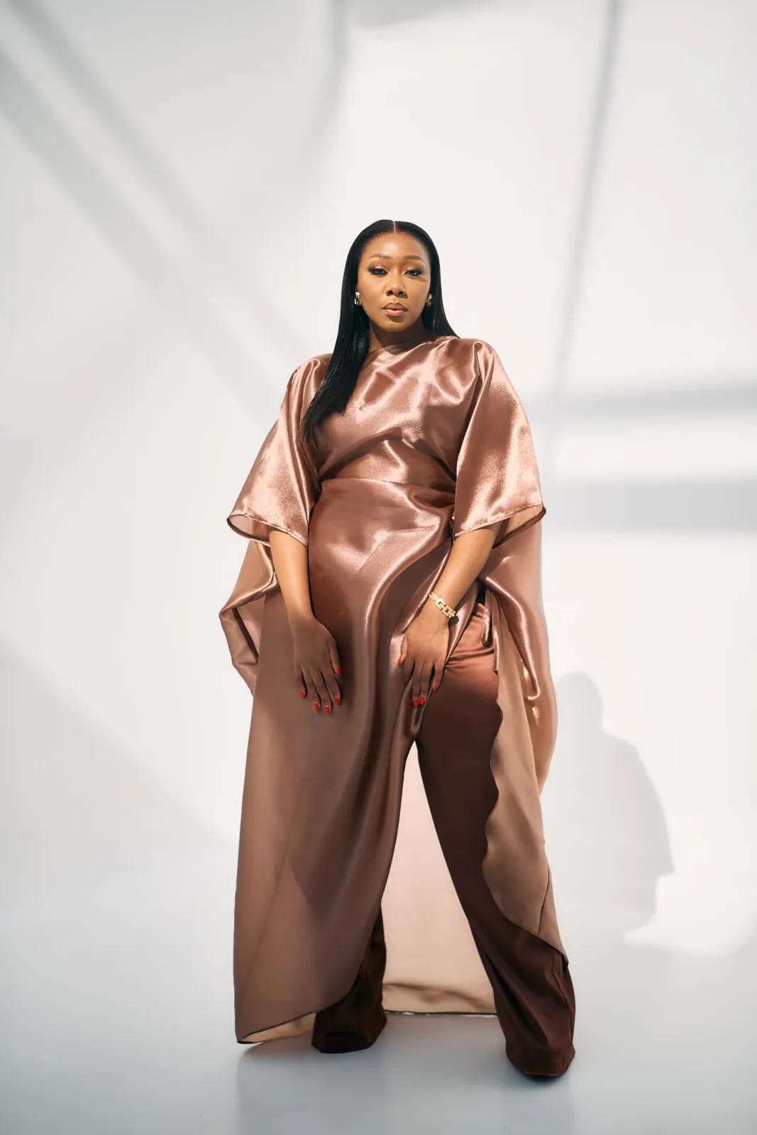 Lebo Lion, author of Audacity, in a rose gold satin gown